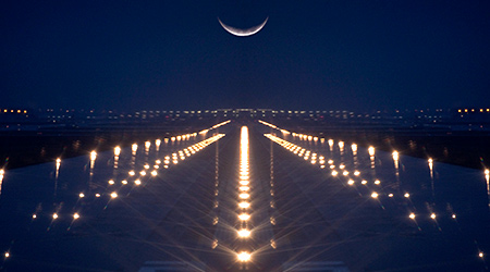 Landing Zone lit up at night with crescent moon