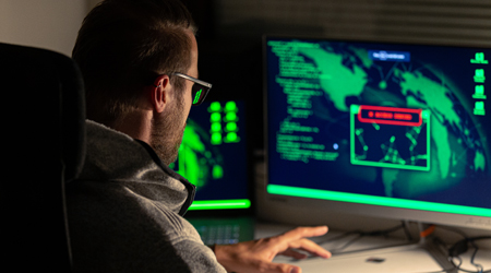 Man looking at screen with global weather