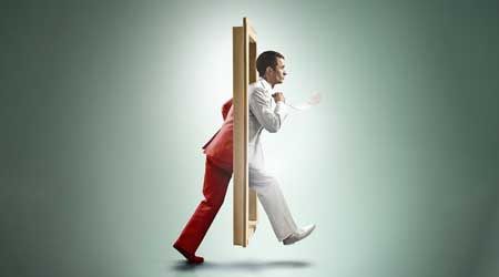 man walking through door in half red and half white suit