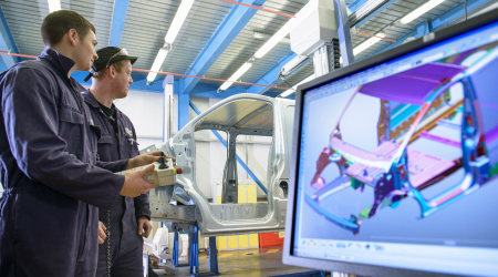 Two workers manipulate 3D Automotive Image on screen