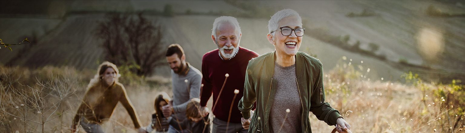 1 old couple and 1 young couple with kid in field