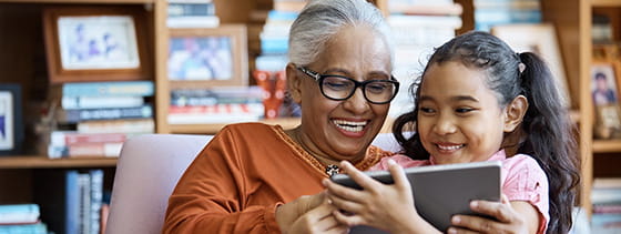 grandmother and granddaughter sitting together laughing