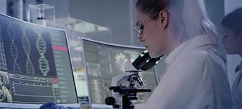 scientist looking at DNA on a screen
