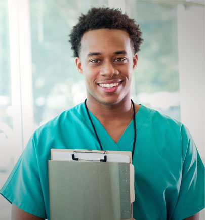 clinician in scrubs holding a clipboard