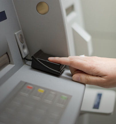managed security services - person using biometrics ATM